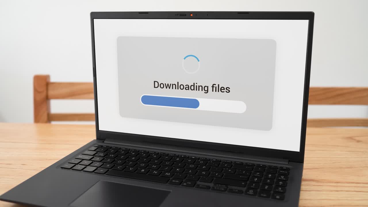 Computer screen downloading files with blue progress bar.