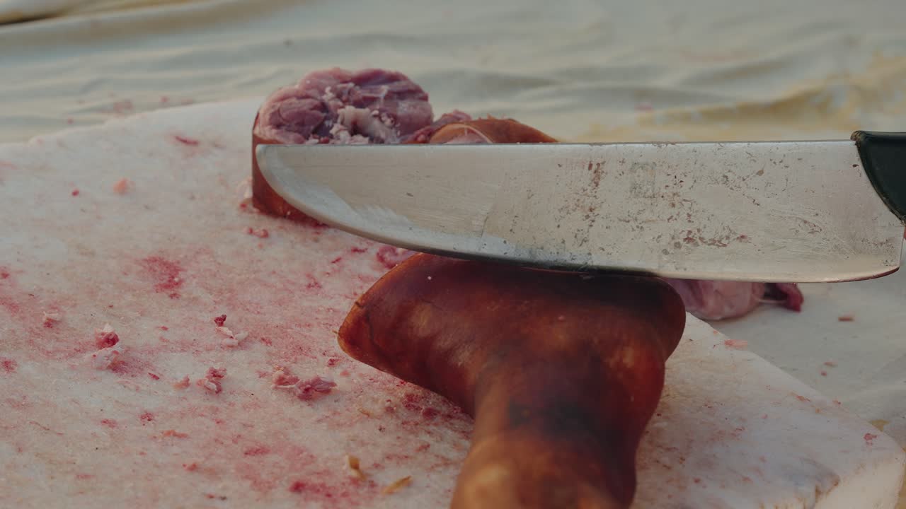 cross sections of pig feet with skin and bone on stained cutting surface