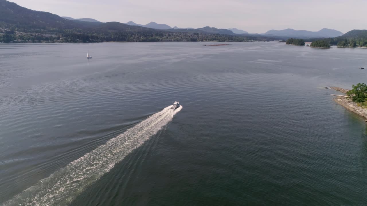 Aerial view of a boat near the coast of Vancouver Island - Canada. Drone footage