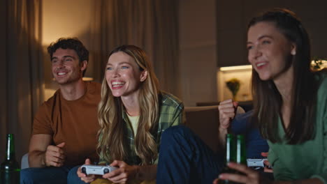 excited friends rejoicing videogame at evening meeting close up. people playing