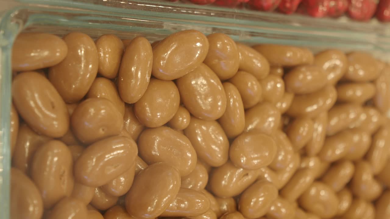 Close-Up of Chocolate Covered Nuts and Berries in a Candy Display