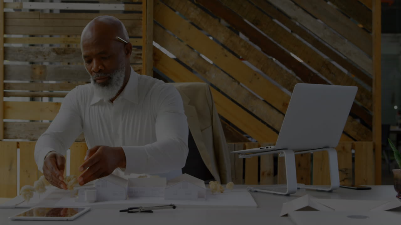 Animation of financial data processing over male architect working in office