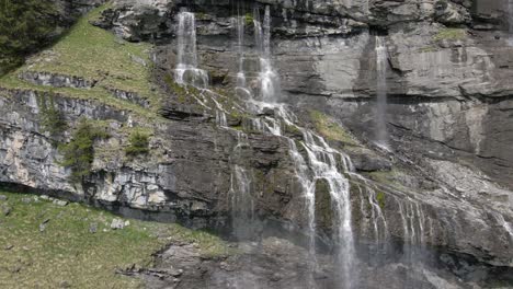 Following-streams-of-water-falling-down-the-side-of-a-mountain-in-the-Swiss-Alps