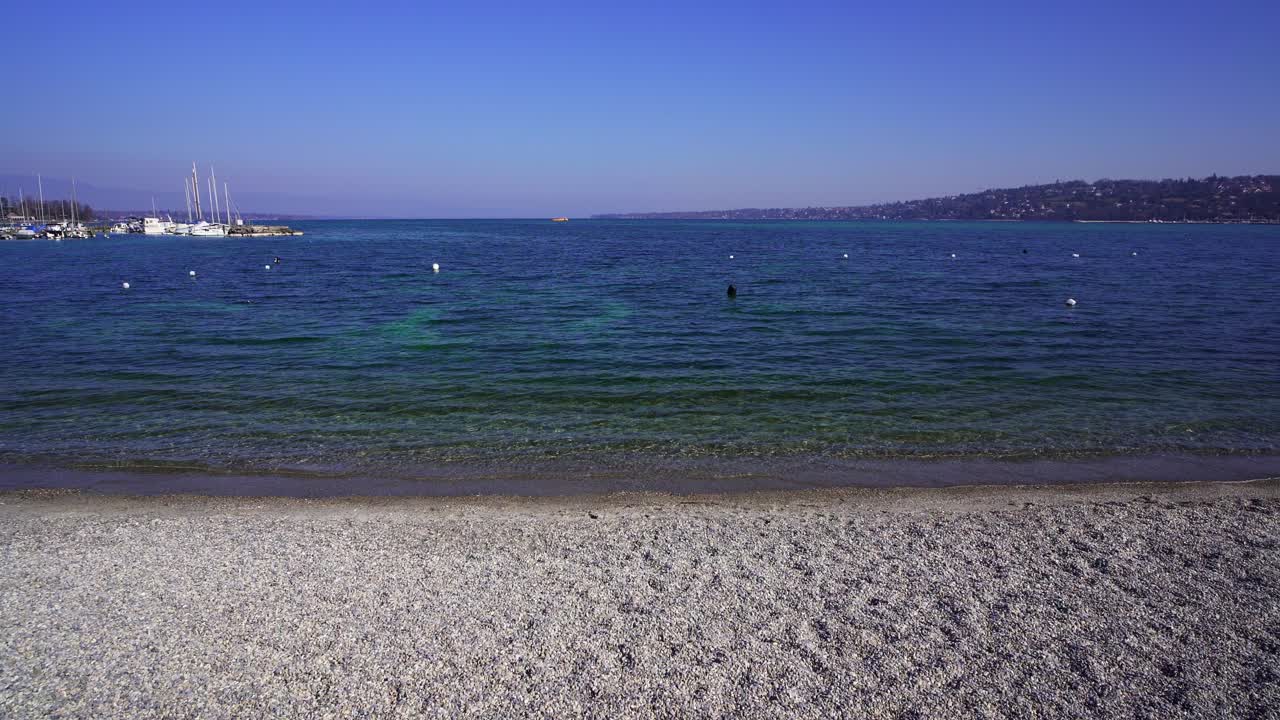 Geneva, the small pebble beach on Bains des Pâquis looking out toward Lake Geneva