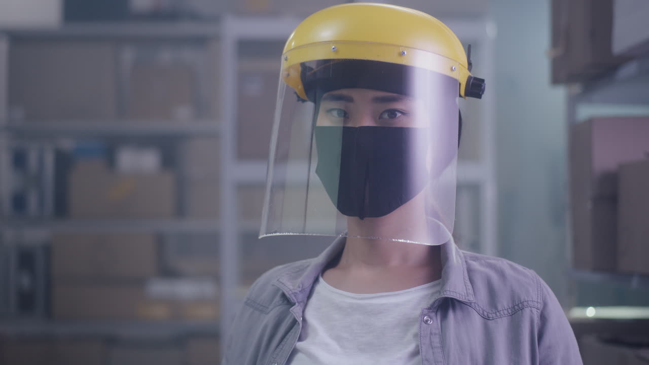 Woman in Warehouse with Protective Gear