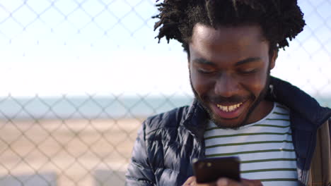 A-black-man-texting-on-social-media-using-a-phone