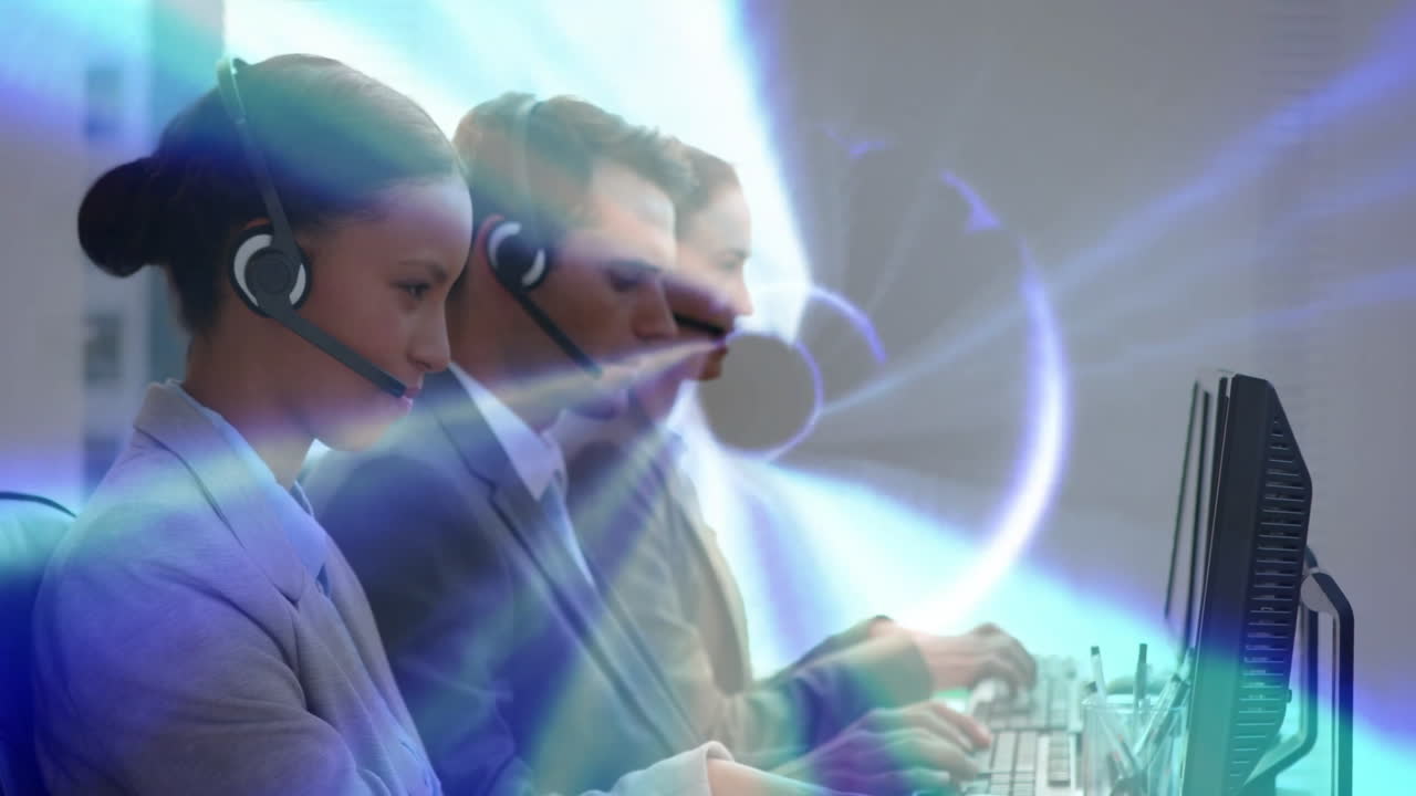 Customer service team working at computers with digital network animation overlay