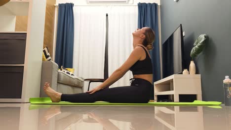 mujer haciendo estiramientos de yoga en casa