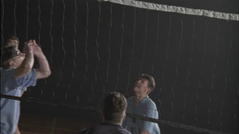 Men-play-volleyball-on-an-indoor-court-1