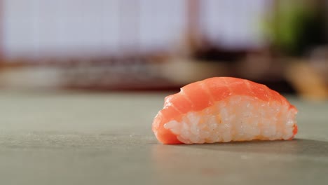 closeup of tuna and salmon nigiri sushi with chopsticks