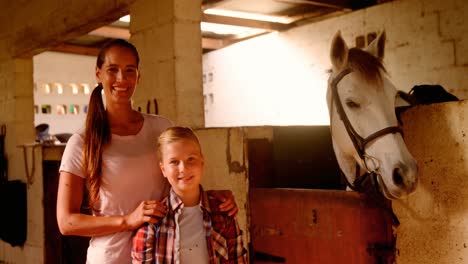 Mother-and-daughter-standing-with-the-horse-4k