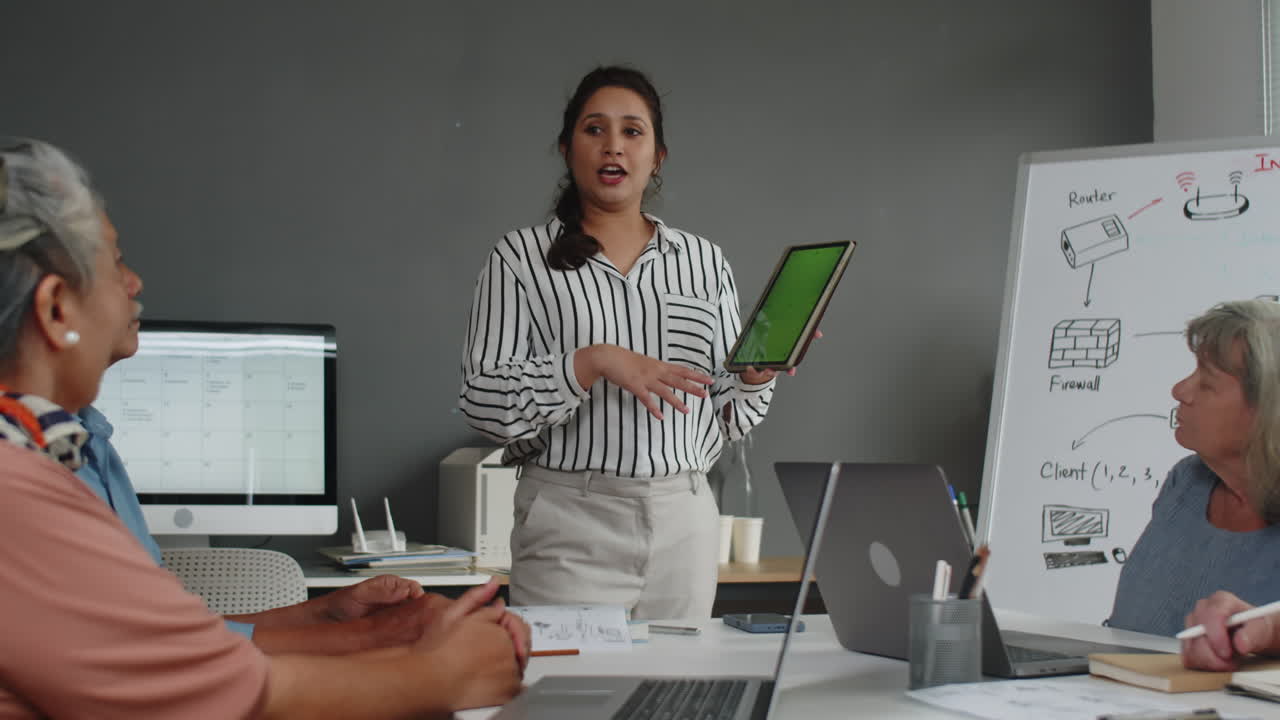 Female Teacher Giving Lesson to Seniors about Digital Tablet Work