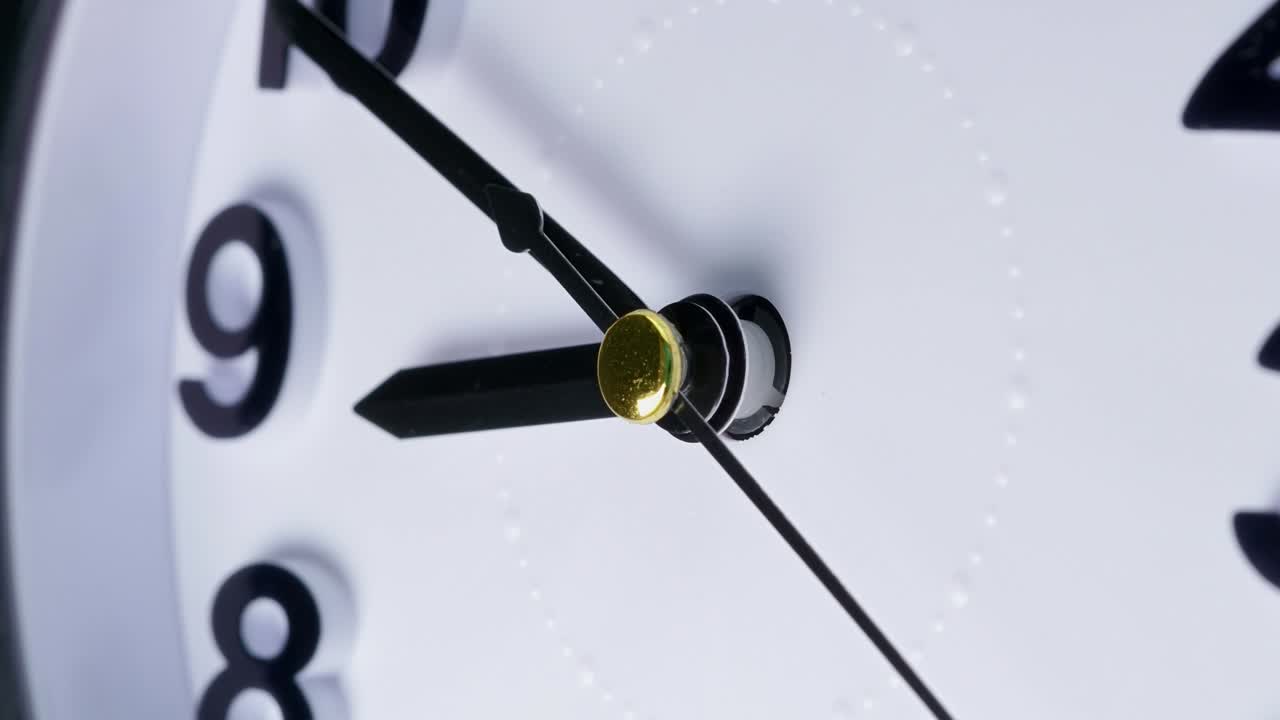 Zoom in to simple white clock dial close-up. Table business timer. Wide macro lens view to the time lapse walking countdown minute. Running time concept. 4k