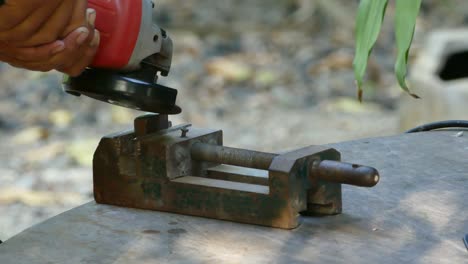 Worker grinding metal construction