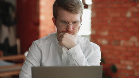 architect or programmer is working remotely sitting in cafe with laptop checking information looking at display