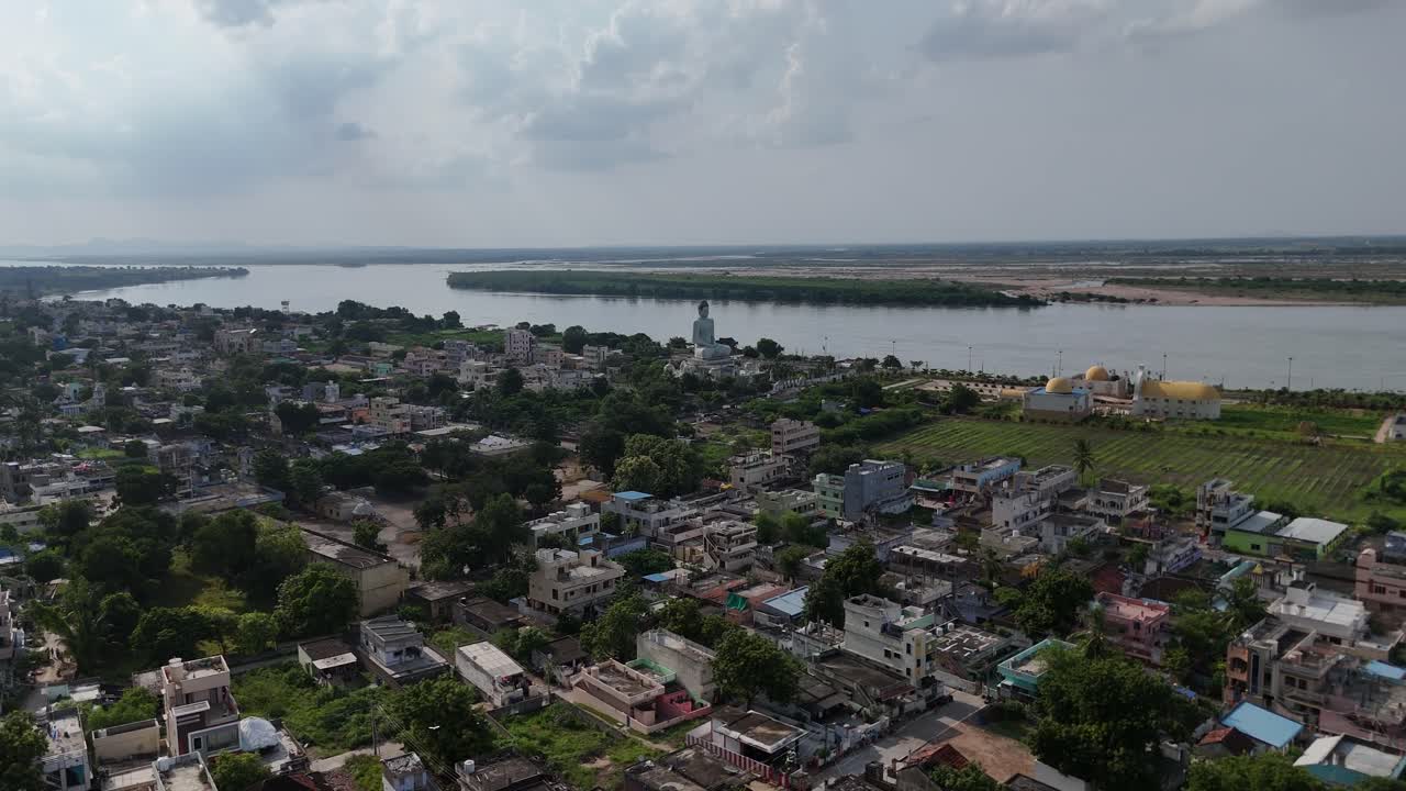 A vibrant aerial view of Vijayawada buddha statue, with a scenic hill providing a striking natural contrast.