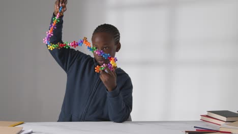 boy on asd spectrum playing with shape puzzle on white background 2