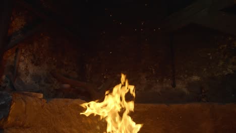 fire burning in a stone fireplace in slow motion, flame rising