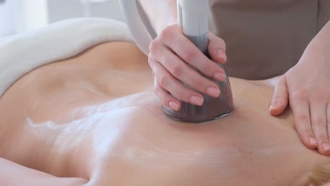 vacuum body massage young woman in beauty salon vacuum body massage young woman in beauty salon an anticellulite rollervacuum massage procedure is available in the beauty salon for the treatment of cellulite problem areas