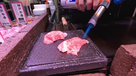 blowtorch used to cook meat slices