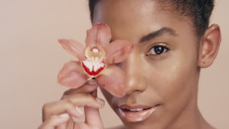 close up beauty portrait beautiful african american woman touching body with orchid flower caressing healthy skin complexion enjoying gentle fragrance of natural essence skincare concept