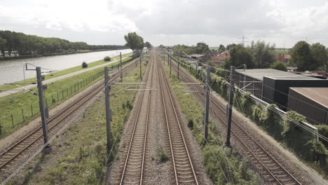 a train of the dutch railway service (ns) passes under the bridge over the amsterdam-rijnkanaal.
