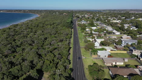 Aerial:-Bellarine-Hwy-parallels-Lonsdale-Bay-in-Point-Lonsdale,-AUS