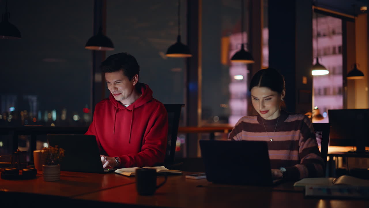Employees working late at night in office