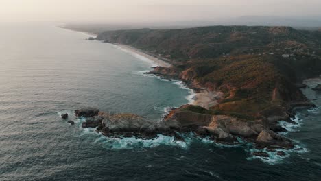 Rocky-Coastline-Of-Punta-Cometa-Peninsula-With-Playa-Mermejita-And-Playa-La-Ventanilla-In-The-Distance-In-Mazunte,-Mexico