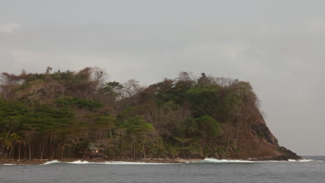 a rustic cabin clings to the jungle above a remote cape in bahía del aguacate.