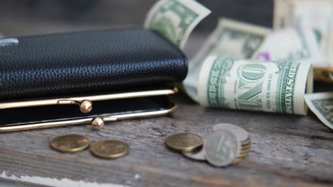 wallet with russian ruble coins and dollars on a wooden background. currency exchange concept. economic crisis, the decline of the world economy. the fall of the russian currency.