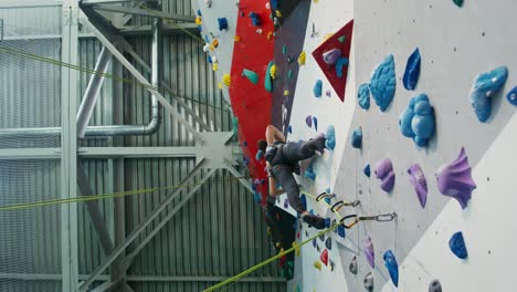 person rock climbing on an indoor climbing wall