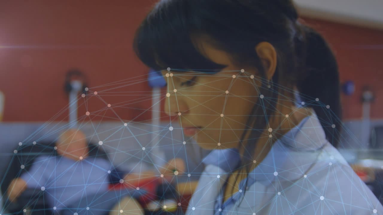 Female clinician tapping tablet, starting animated network, reviewing clinical notes beside patient