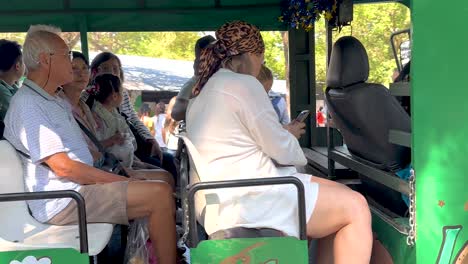 group of people on a sightseeing bus in a park