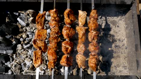 top view on shish kebab cooked on the grill in nature. street food