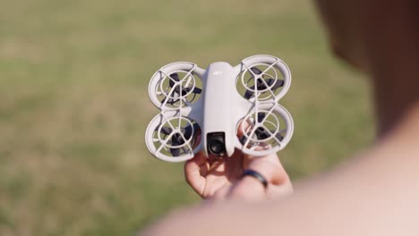 person holding a dji mini drone outdoors