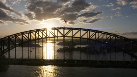drone dolley shot of sydney harbour bridge during golden hour
