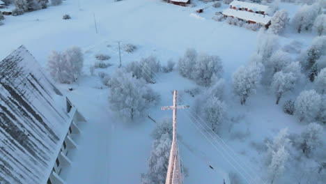 aerial view circling the cross on the salla church, winter sunrise in finland