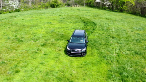 vehicle of property surveyors driving through verdant field