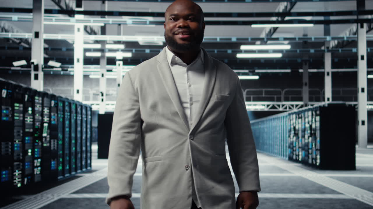 Vertical video Smiling employee walking in high tech data center