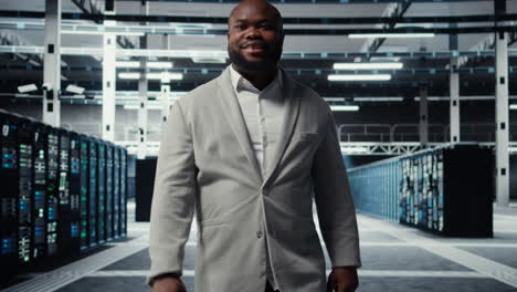 vertical video smiling employee walking in high tech data center