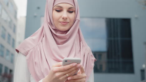 woman in hijab using smartphone