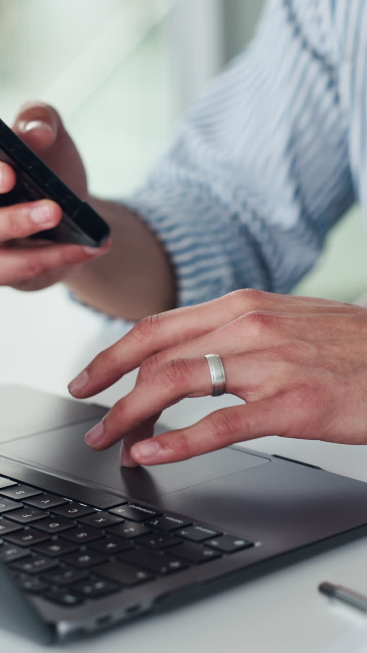 Close-Up of Man's Hands Using Smartphone and Laptop