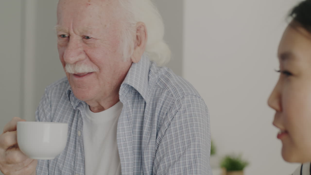 Elderly Man Talking With Caregiver