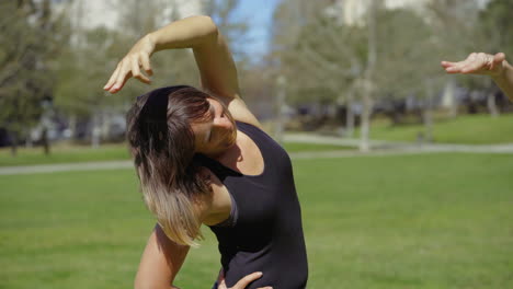 Two-cheerful-women-stretching-arms-before-training.