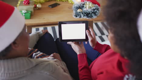 african american mother and adult daughter on tablet christmas video call, copy space, slow motion