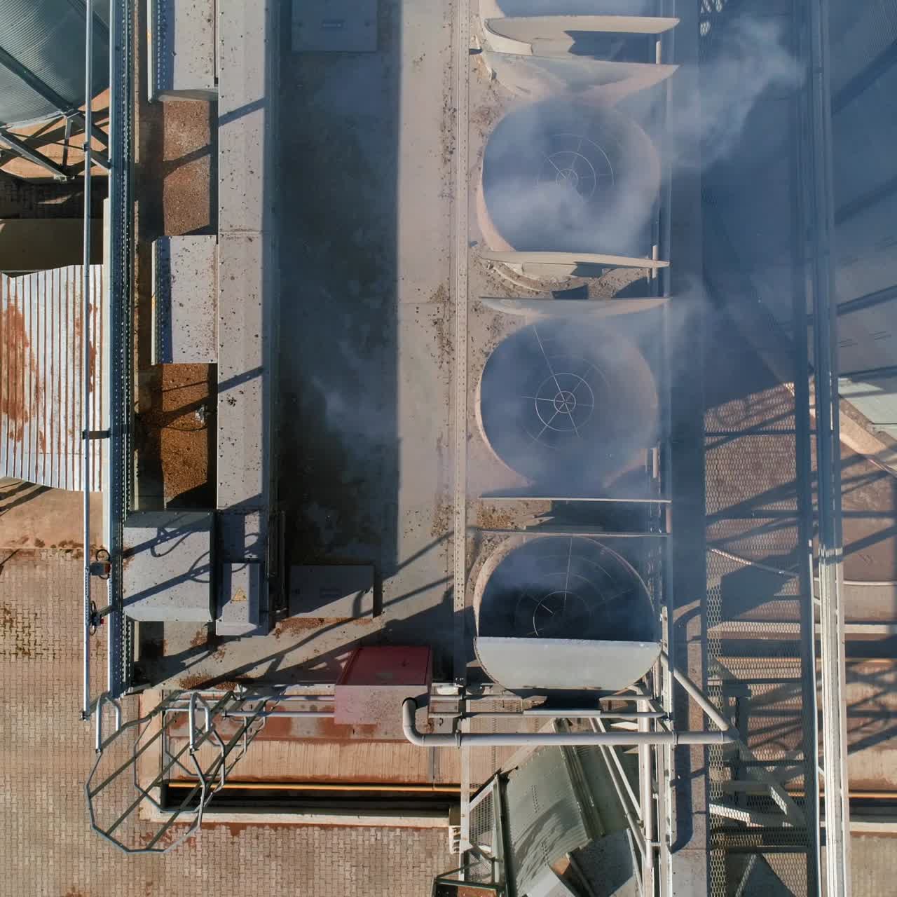 Outdoor metal air dust or smoke ventilation system of a factory modern industry. Pipes of grain or crop elevators. Video from the top