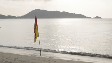 the beach with white sand and calm wave from peaceful sea in summer sunshine daytime