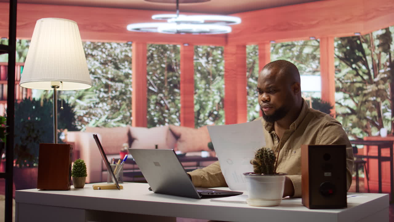 Entrepreneur taking notes and managing business analytics at his home office