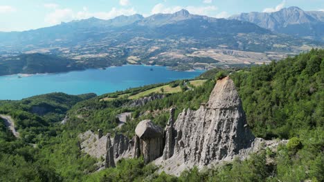 rock formation and nature landscape at lake serre poncon, french alps, france - aerial 4k